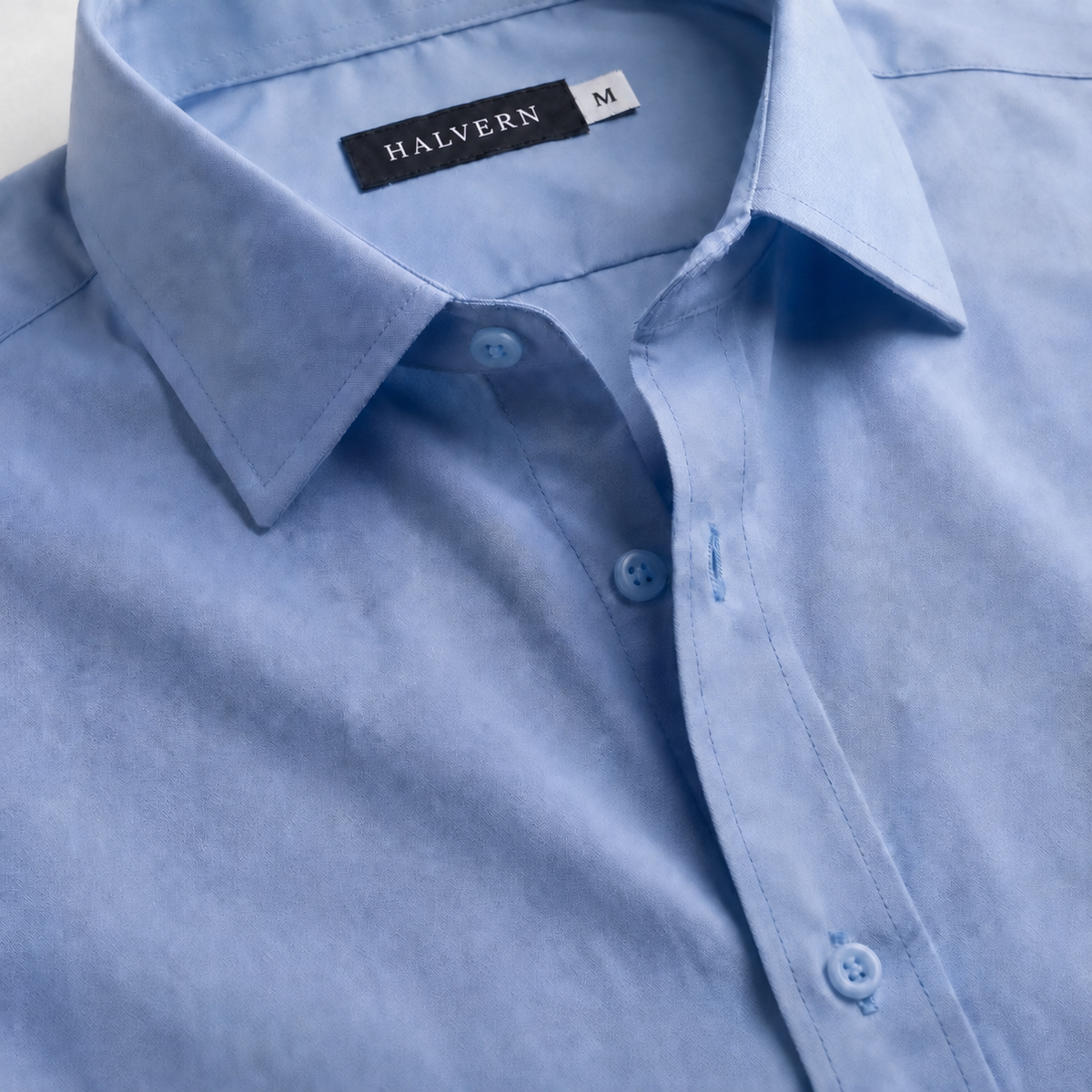 Close-up of Halvern Glatt light-blue shirt label and fabric
